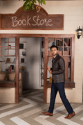 DASTAN TERRACOTTA SENTINEL brown leather jacket, bookstore lifestyle view