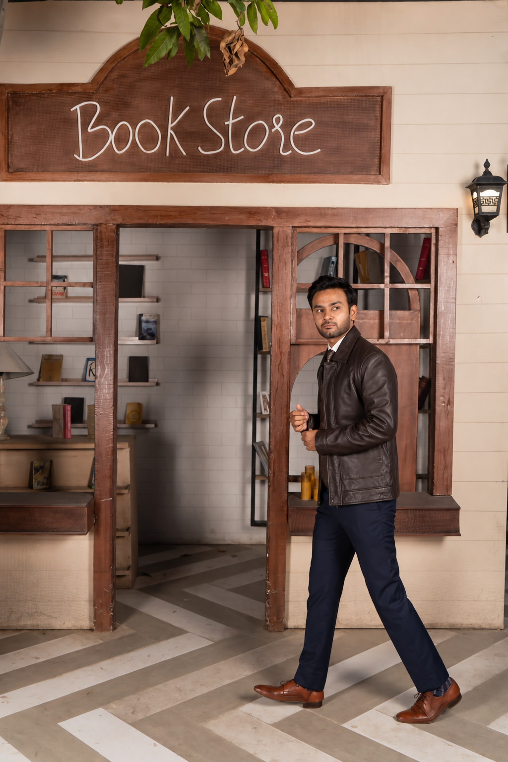 DASTAN TERRACOTTA SENTINEL brown leather jacket, bookstore lifestyle view